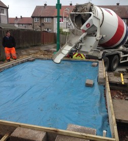 Pouring cement on brick garage foundations